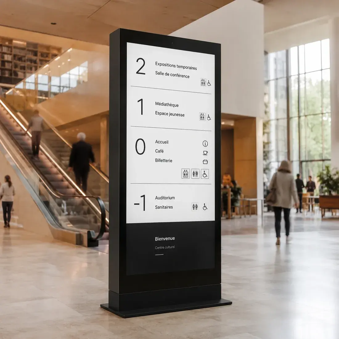 Totem numérique d'orientation dans un hall, listant les services disponibles par niveau